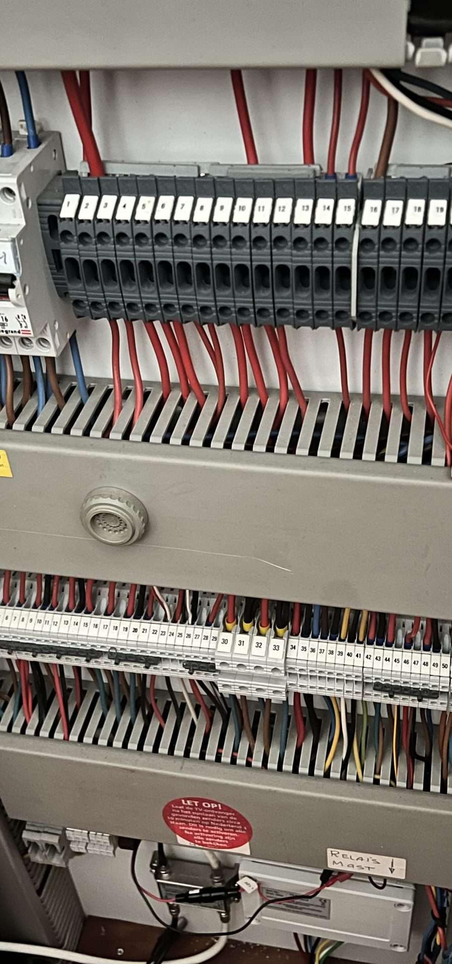 Elektrische installatie met zekeringen, draden, omvormer en relais.